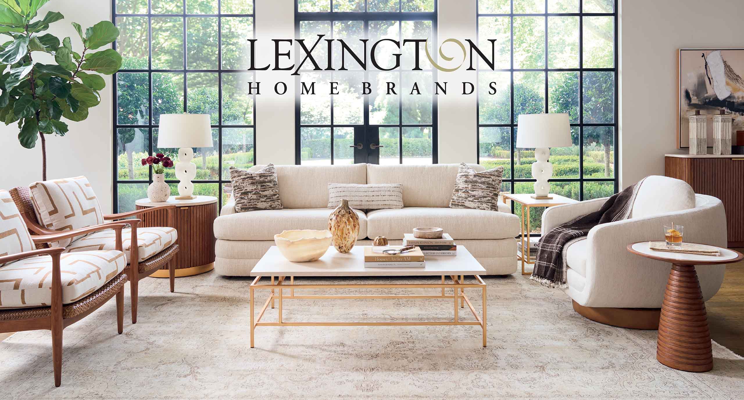 08-2026 LexingtonFallSale-Banner 25602 Lexington Fall Sale at IDS, August 27 - Sept. 30, 2026. Living room with a beige sofa, patterned chairs, glass coffee table, and large grid windows; Lexington Home Brands banner across the top.