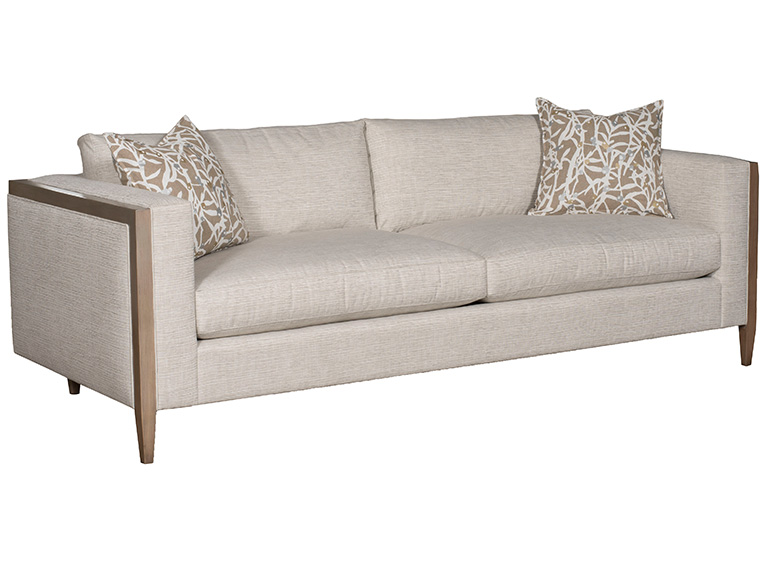 08-2026-SS-F-Vanguard Vanguard sofa in light neutral upholstery with wood-trimmed arms and two patterned accent pillows.